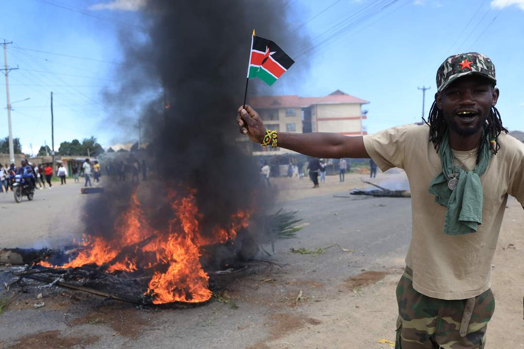 Protesters march toward the entrance of Laikipia Air Base and chant slogans during a demonstration against plans to establish an Ebola quarantine facility for US citizens diagnosed with Ebola in Nanyuki, Kenya.